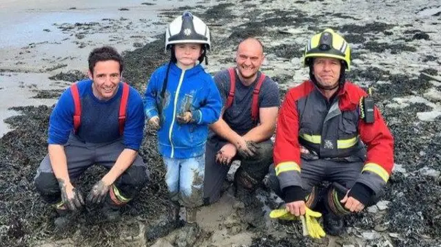 Child who got stuck in the mud with firefighters