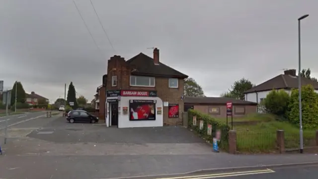 Off licence building on street corner