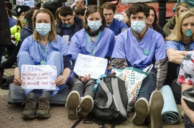 Junior doctors sit down in a silent protest outside Bristol Royal Infirmary