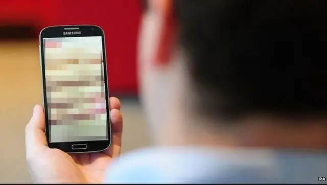 Man looking at pixilated image on phone