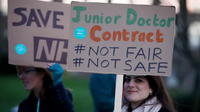 Junior doctors on strike holding signs