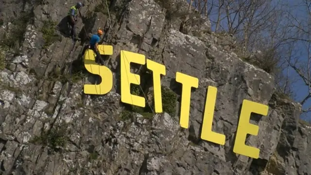 Settle lettering on cliff above town