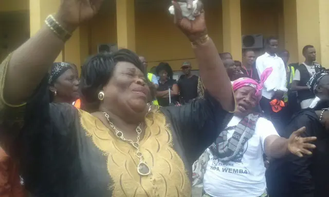 Woman raises her arms in a sign of mourning