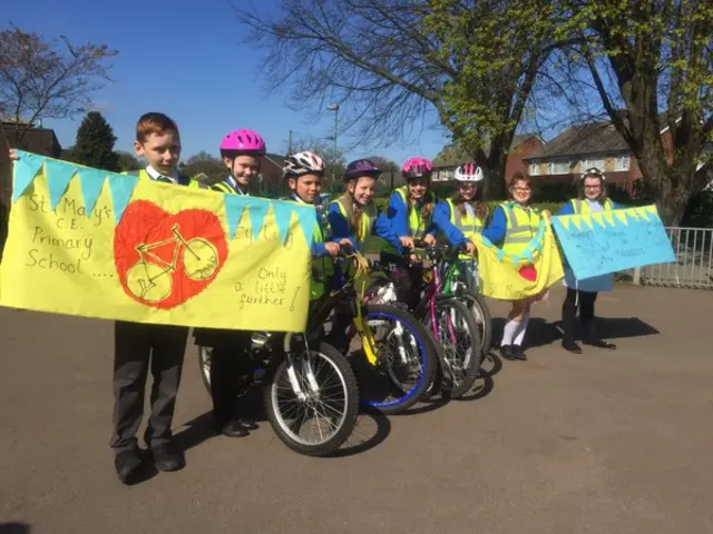 pupils hold flag