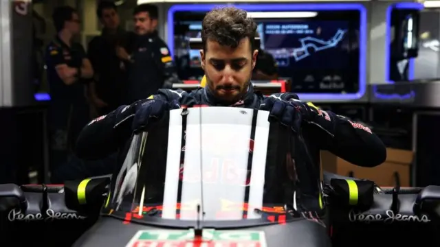 Daniel Ricciardo climbs into his car with the "aeroscreen"