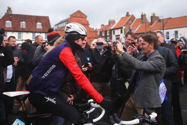 Spectator taking photo of Sir Bradley Wiggins