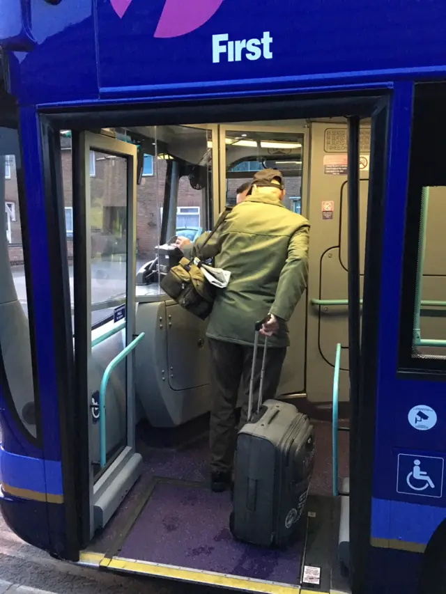 Malcolm Metcalf boarding a bus at the start of his journey