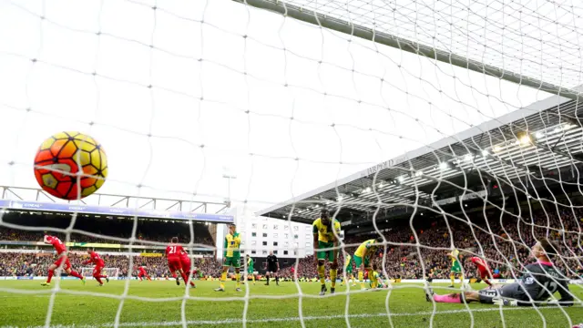 Adam Lallana (1st L) of Liverpool celebrates scoring his team's fifth goal during the Barclays Premier League match between Norwich City and Liverpool at Carrow Road on January 23, 2016