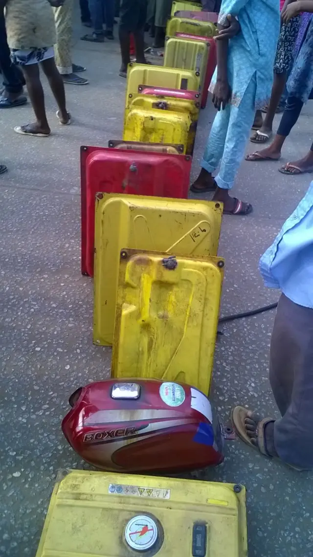 Line of petrol tanks waiting at at a filling station