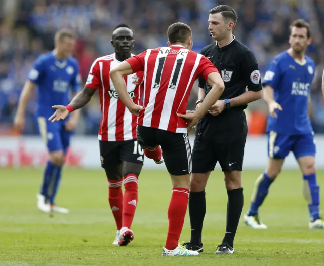 Dusan Tadic speaks with referee Michael Oliver