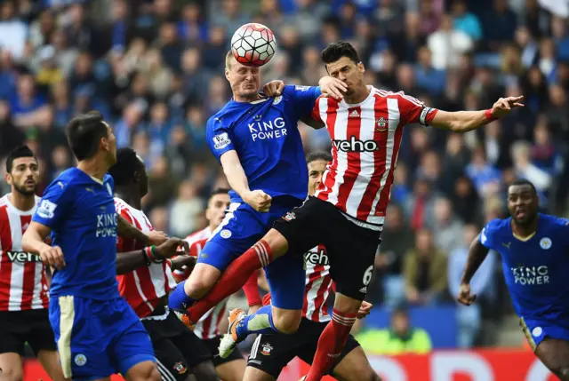 Robert Huth of Leicester City jumps with Jose Fonte