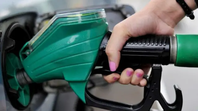 Woman filling car with fuel