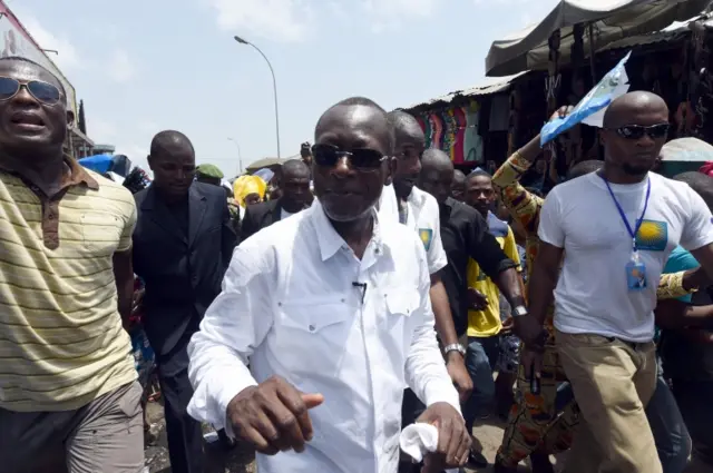 This file photo taken on March 4, 2016 shows cotton tycoon and presidential candidate Patrice Talon (C) flanked by supporters arriving for a rally in Cotonou