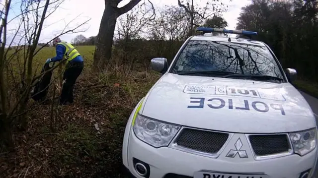 Police man collecting bags