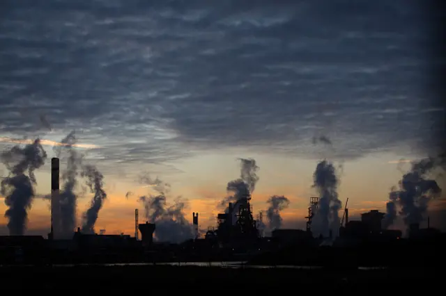 The sun rises behind the Tata steelworks