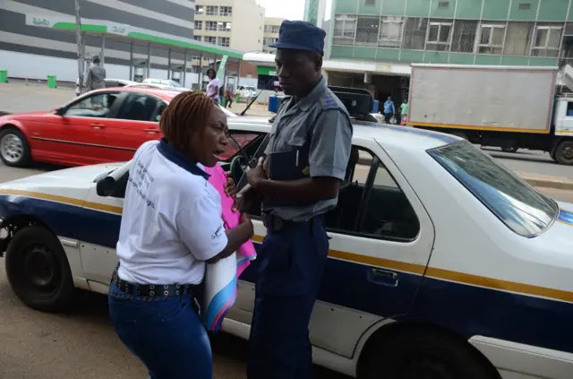 Protester and police in Harare 6 April 2016