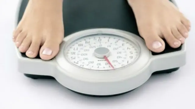 Woman on weighing scales