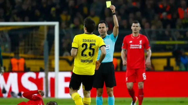 Sokratis Papastathopoulos is shown a yellow card