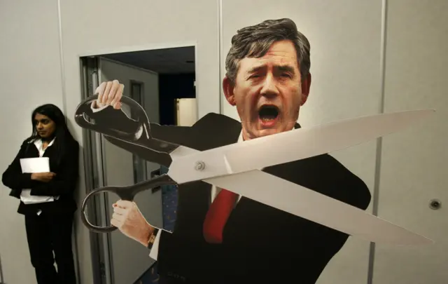 Gordon Brown holds a scissors