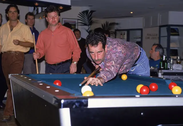 Sam Torrance takes a shot on the pool table