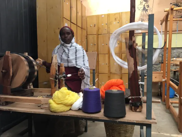 Ethiopian woman working at a loom in a fashion house