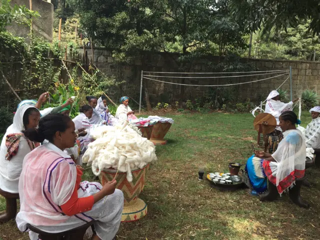 Ethiopian women doing threadwork outside