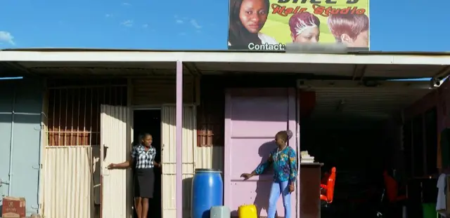 Sharon outside her salon in a shipping container