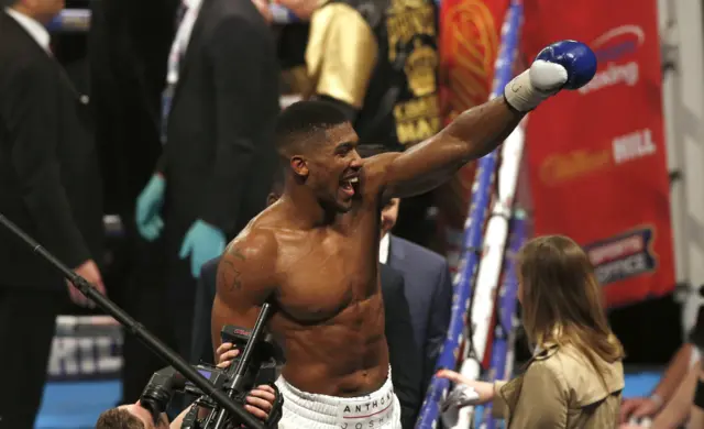 Anthony Joshua celebrates after win