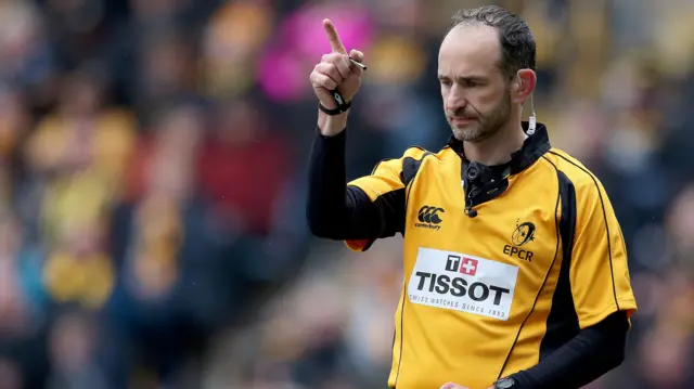 Referee Romain Poite signals