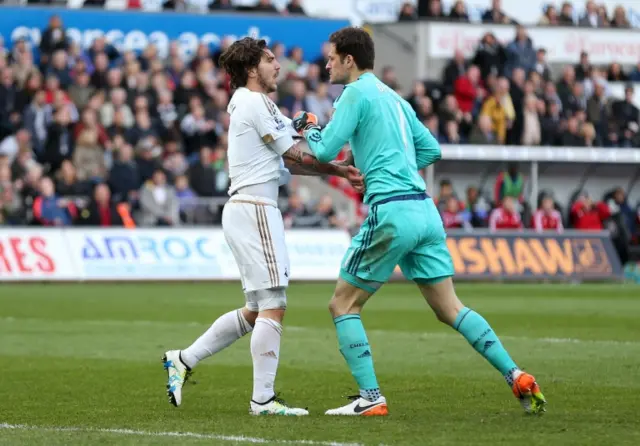 Chelsea"s Asmir Begovic clashes with Swansea"s Alberto Paloschi