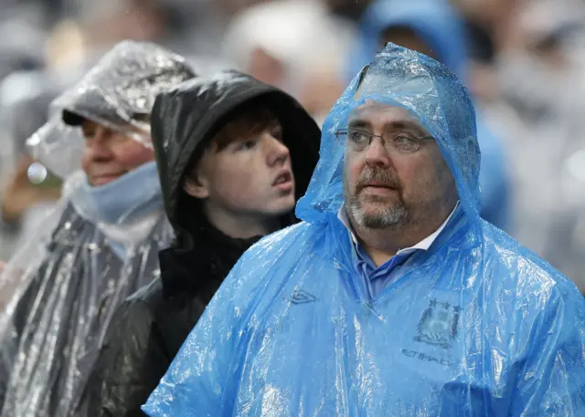 Manchester City fans in the rain