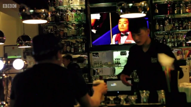 Ding Junhui on TV in a bar in Beijing