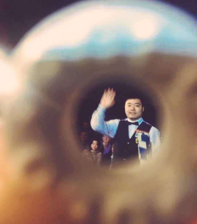 Ding Junhui through a polo