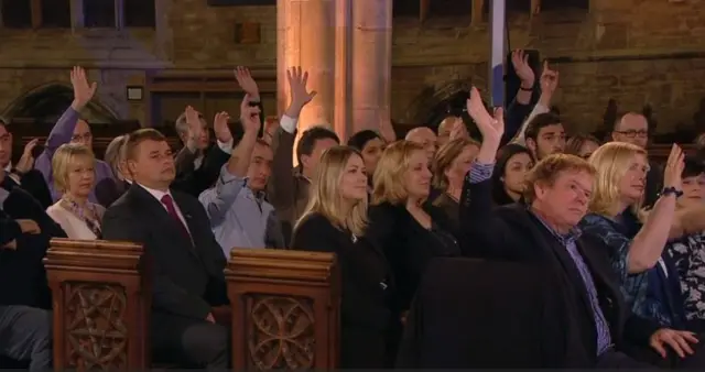 About half the audience raise their hands