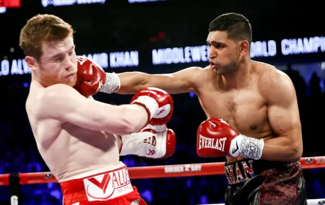 Canelo Alvarez, left, is hit by Amir Khan during their WBC middleweight title fight Saturday, May 7, 2016, in Las Vegas.