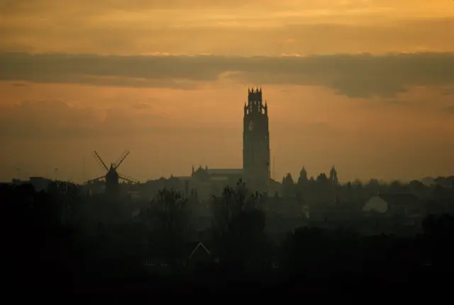 Silhouetted 272-foot tower of St Botolph's church at twilight