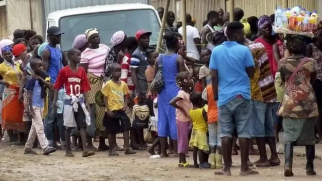 People wait in line to receive a yellow fever vaccine in Luanda, Angola