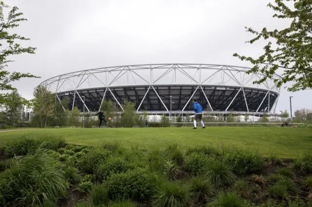 Kids play on a pitch outside of the Olympic Stadium