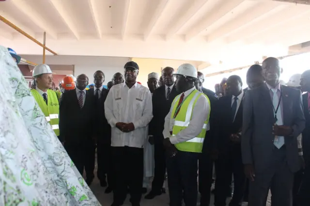 Prime Minister Philemon Yang (in white) visiting works at the Ahmadou Ahidjo Stadium in Cameroon