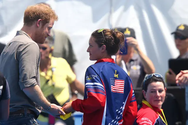 Sergeant Elizabeth Marks handing her award back to Prince Harry