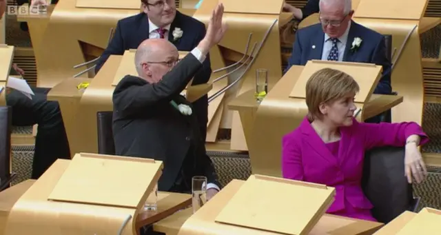 First Minister Nicola Sturgeon and Deputy First Minister John Swinney spot a familiar face in the gallery