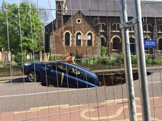 A man attaches the rope to the car