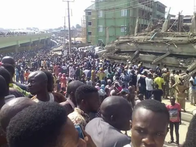 Crowds looking at a shopping mall which has collapsed in Abeokuta, Nigeria