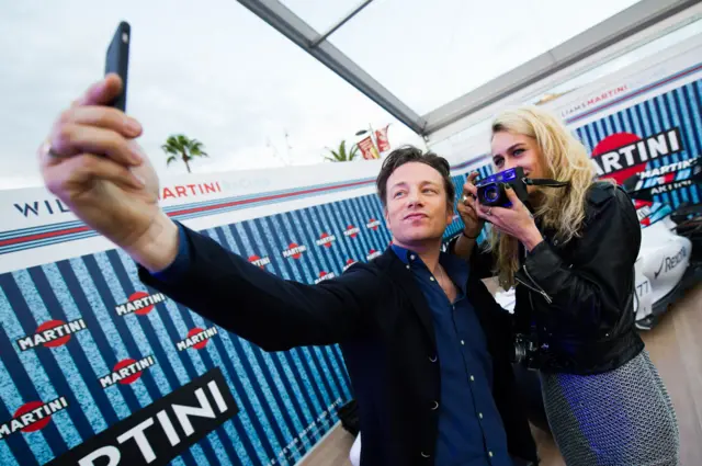 Jamie Oliver taking a selfie at the Spanish grand prix first practice