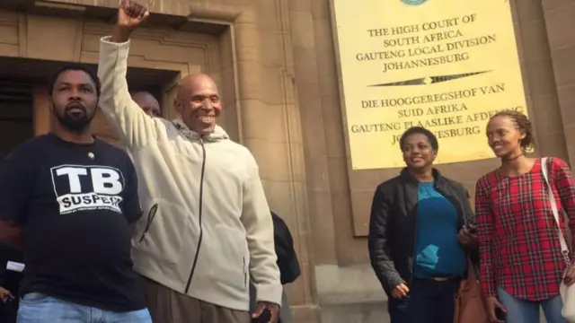 A man raising his first outside the high court in Johannesburg, South Africa - Friday 13 May 2013