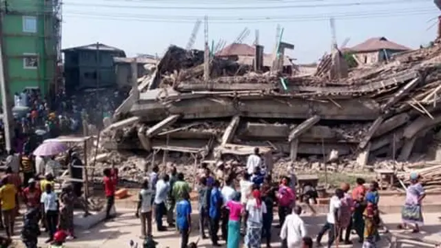 Crowds looking at a shopping mall which has collapsed in Abeokuta, Nigeria