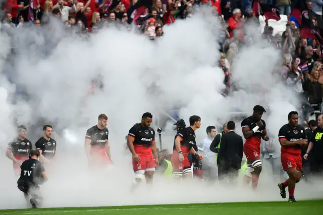 Saracens players enter the pitch