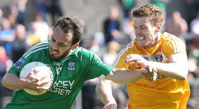 Antrim's Martin Johnston attempts to win the ball off Paul McCusker of Fermanagh