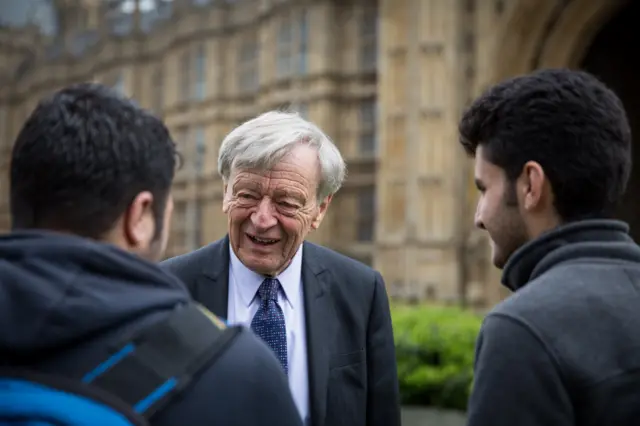 Lord Alf Dubs speaks to two child refugees from Syria on College Green on April 25, 2016 in London, England