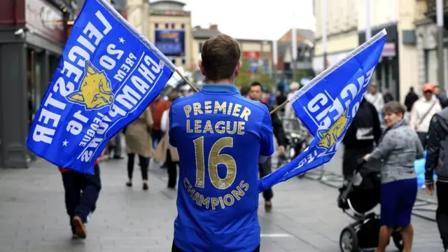 A Leicester City fan shows support for his side ahead of the open top bus parade through Leicester City Centre